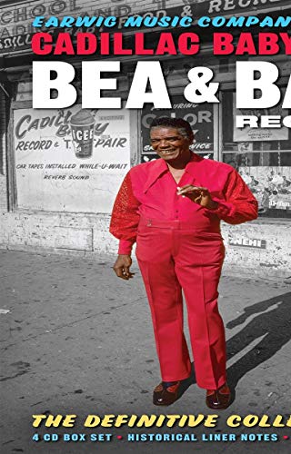 CD cover featuring a man in a red suit standing in front of a building.