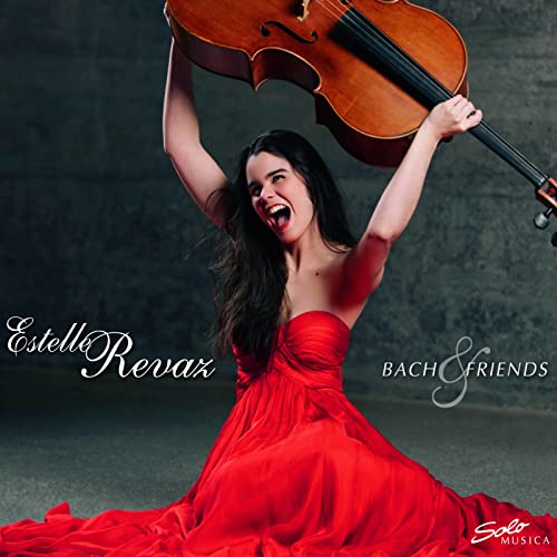 Woman in red dress raising arms with a cello above her.