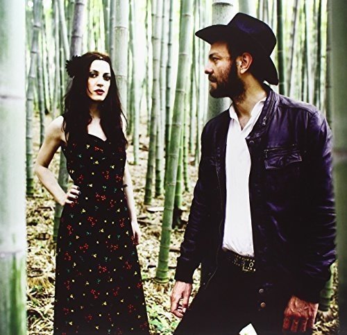 Two people in a bamboo forest, a woman and a bearded man.