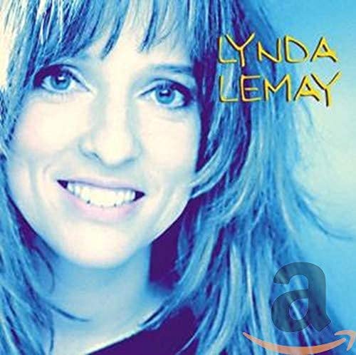 Close-up portrait of Lynda Lemay with blue hair and eyes.