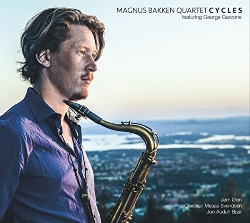 Man with brown hair playing saxophone, blue shirt, cityscape background, album cover.