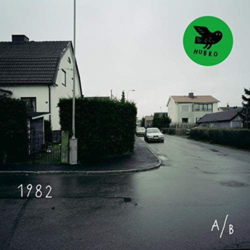 CD cover with a suburban street scene and green bird logo.