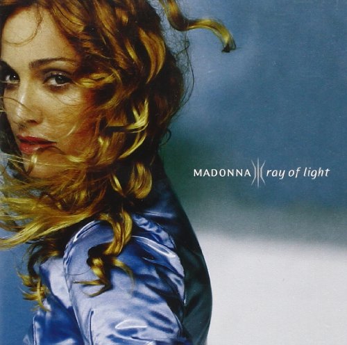 Madonna album cover: a woman with blonde hair and blue shirt against a blue background.