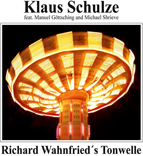 CD cover showing a spinning carnival ride with motion-blurred yellow lights against black.