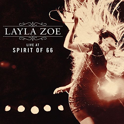 A CD cover featuring a woman singing into a microphone on a dark stage.