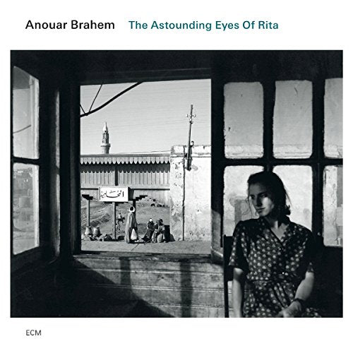 Black and white album cover with a woman standing by a window.