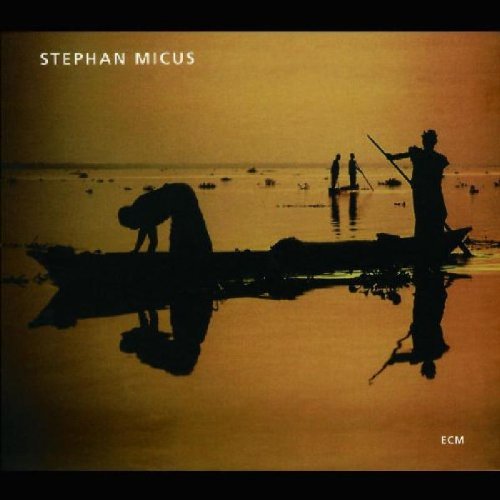 "CD cover with silhouetted figures in boats on calm water, yellow-orange background."
