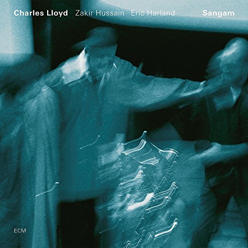 The image is a CD cover for the album "Sangam" by Charles Lloyd, Zakir Hussain, and Eric Harland. The cover features a blue-tinted photograph of a person sitting in a chair, with their legs crossed and hands resting on their lap. The person's face is not visible. To describe the image in 15 words or less for accessibility purposes, you could say: "Blue-toned CD cover with a person sitting in a chair, legs crossed."