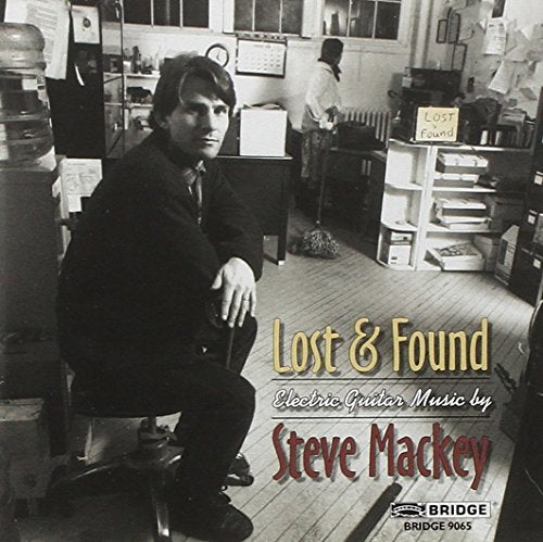 "Album cover featuring a man sitting in an office, with 'Lost & Found' text."