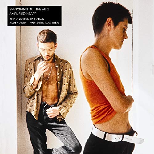 A man and woman stand in a bright room on this album cover.