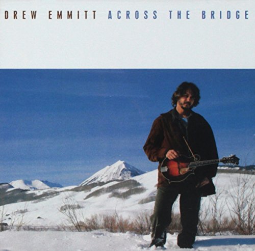 Album cover with a man holding a guitar in a snowy landscape.