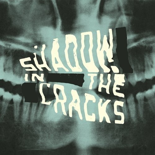 Album cover with text "Shadow In The Cracks" over a dental x-ray.