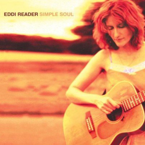 "Album cover featuring a woman playing guitar on a beach at sunset."