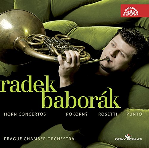 CD cover with a man playing a French horn on a green sofa.