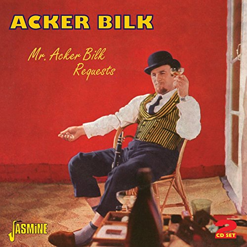 Acker Bilk sitting on a chair, drinking, against a red wall, on a CD cover.