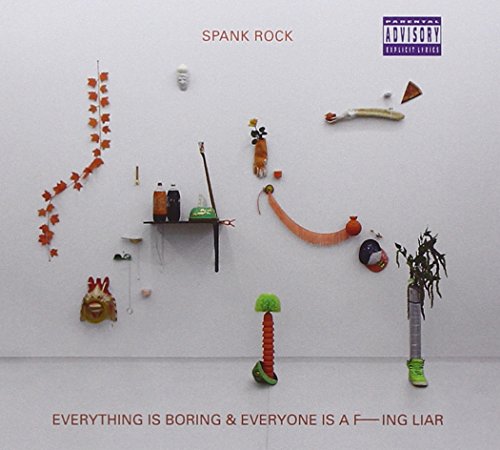 CD cover: white wall with scattered objects and text below.
