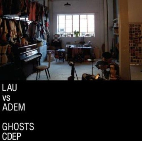 A cluttered music room with a piano, drum set, and clothing, with white text overlay.