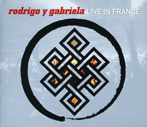 "Album cover with geometric design, red and white text on light blue background."
