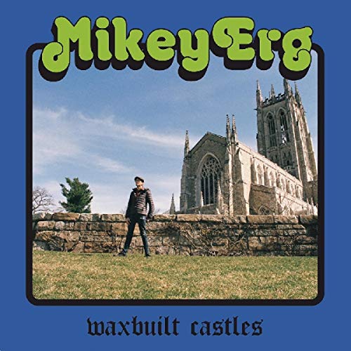 Album cover with man standing before a stone church on blue background.