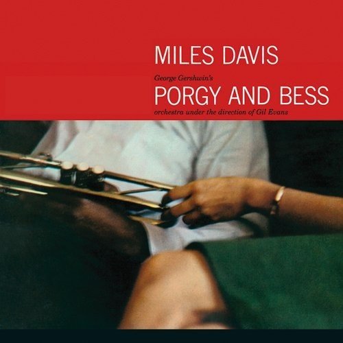 "Miles Davis album cover with man holding trumpet, red background, white text."