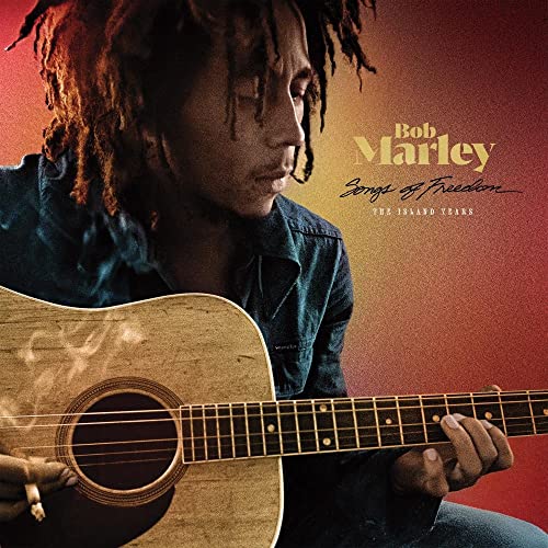Bob Marley with guitar on album cover, “Songs of Freedom.”