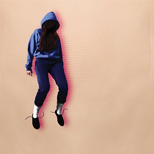 Hooded figure in blue sweatsuit against a textured pink background.