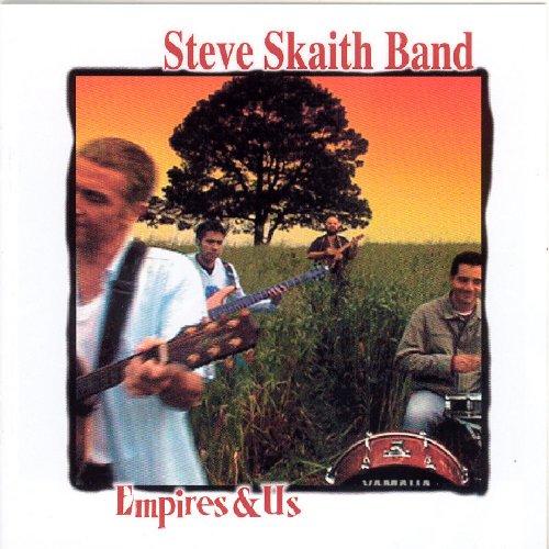 "CD cover with four men playing instruments in a field, tree in background."