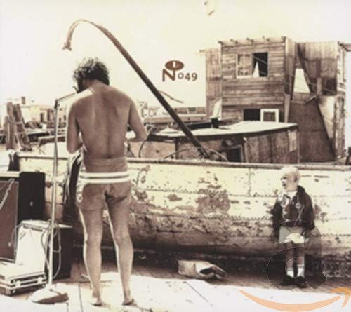 Sepia-toned album cover with a man, child, and weathered boat structure.