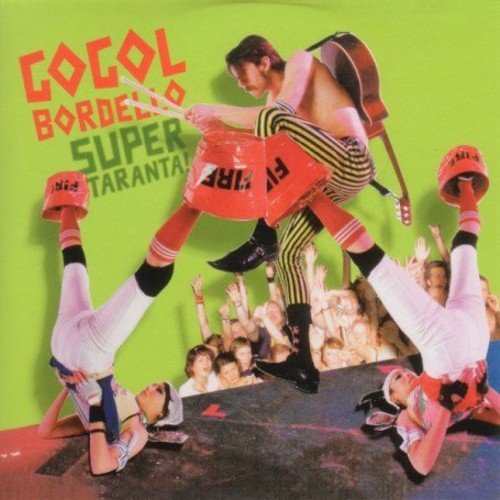 "Gogol Bordello album cover with shirtless man and dancers on green background."
