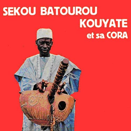 Sekou Batourou Kouyate playing a large, gourd-like stringed instrument.