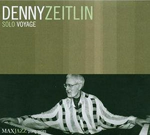 "Album cover with Denny Zeitlin sitting, wearing glasses and a striped shirt, against a green background."