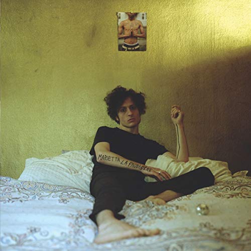 Vinyl record cover featuring a man sitting on a bed with a poster above.
