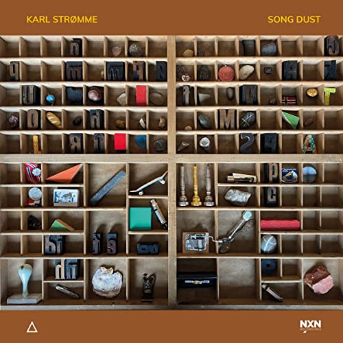 CD cover: wooden cabinet filled with small objects and letterpress blocks.