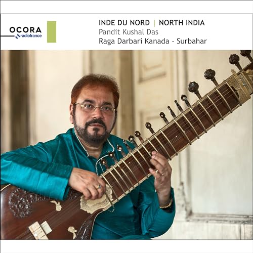 Pandit Kushal Das with a surbahar, a long-necked stringed instrument.