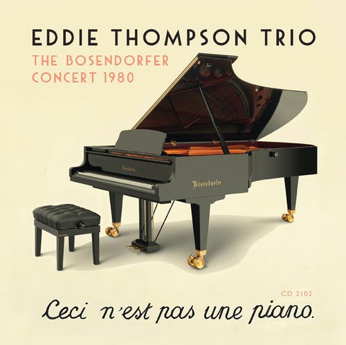 Black Bösendorfer grand piano and stool on a pale yellow background.