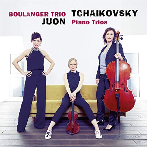 CD cover featuring three women musicians posing with their instruments on a yellow sofa.
