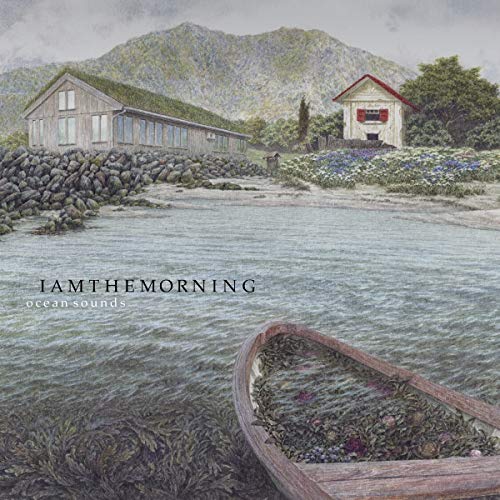 "Album cover with serene lake scene, wooden boat, and houses, titled 'IAMTHEMORNING oceansounds'."