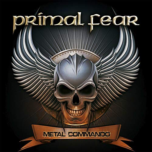 The image depicts the album cover for "Metal Commando" by Primal Fear. Key visual characteristics include: * A silver skull with a menacing grin * Wings spread out behind the skull * The band's name "Primal Fear" written in gold at the top * The album title "Metal Commando" on a bronze banner at the bottom A suitable alt text could be: "Album cover featuring a skull with wings and the title 'Metal Commando'."
