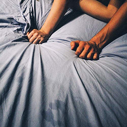 A vinyl record cover featuring two people holding bed sheets, with a blue-gray sheet.