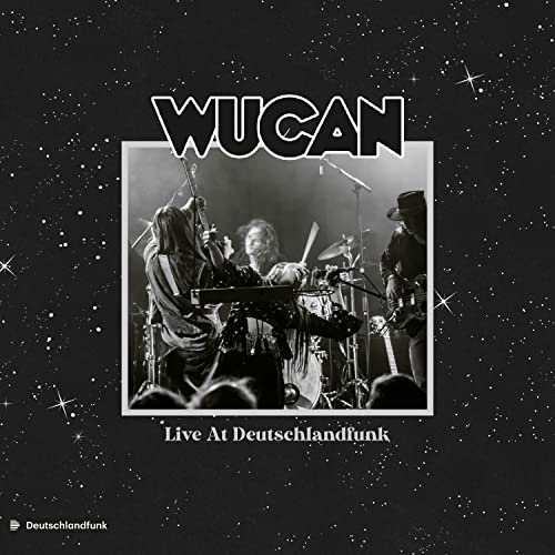 Black and white album cover featuring a band performing live on stage.