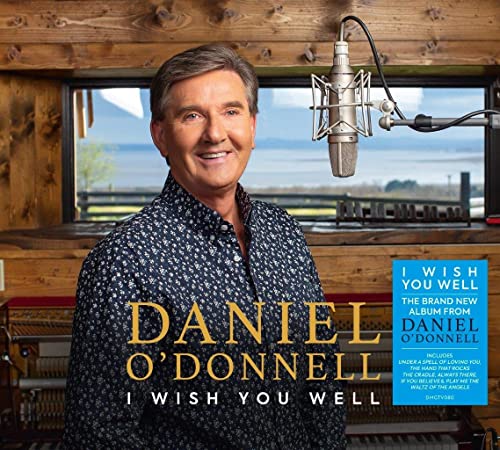 CD cover featuring singer Daniel O'Donnell smiling, with microphone and piano.
