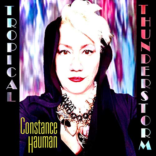 Album cover with a woman in dark attire and bold typography.