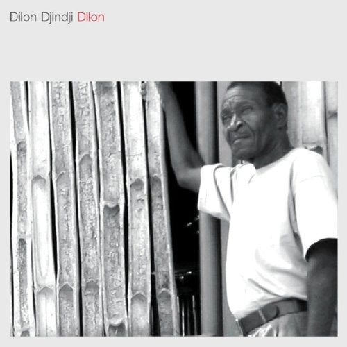 "Album cover with a black and white photo of a man leaning against bamboo stalks."
