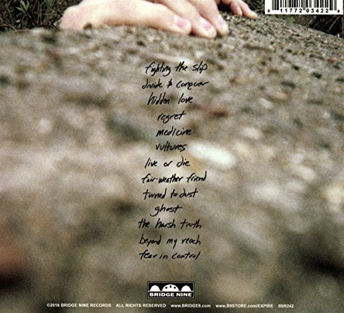 Compact disc with a black and white cover, titled "Expire - With Regret".