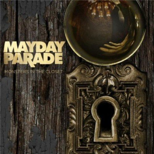 "Album cover with ornate door knob and keyhole on a wooden background."