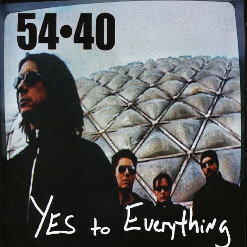 Album cover with four men in sunglasses and a geometric pattern in the background.