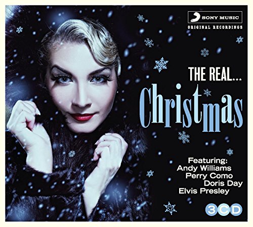 CD cover for "The Real Christmas" featuring a woman in a fur coat.