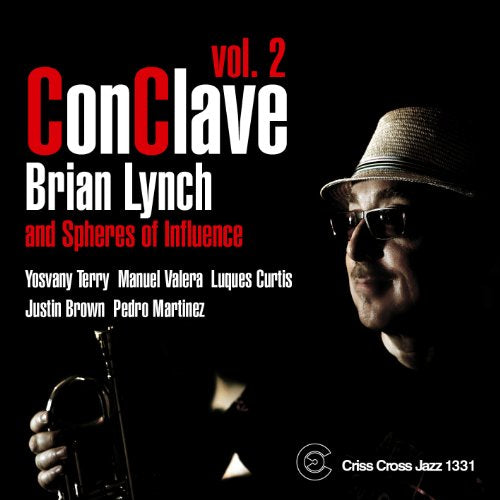 "Album cover with a man holding a trumpet, wearing a hat and sunglasses."