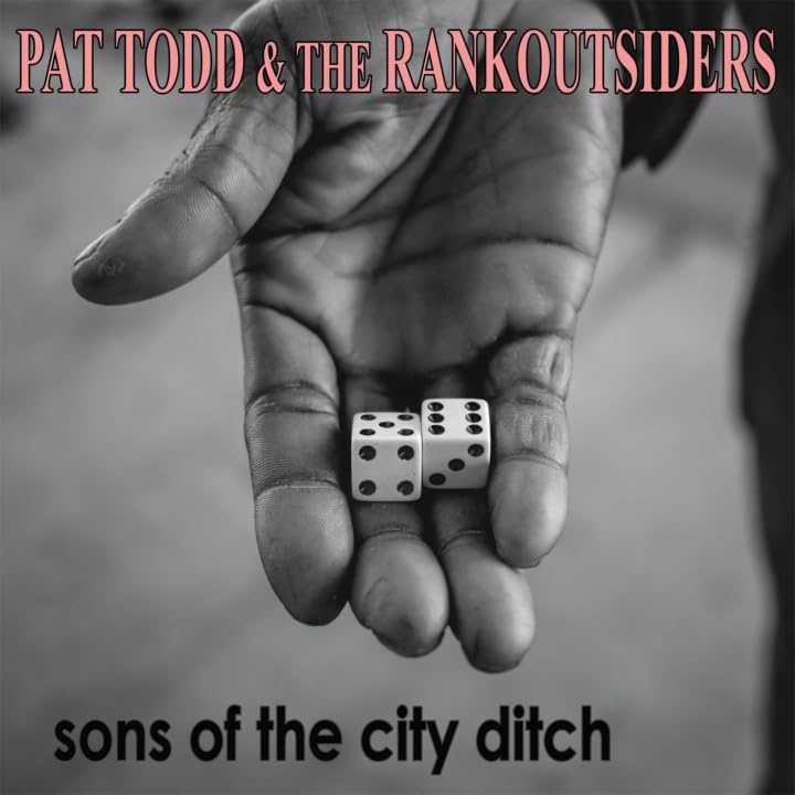 Black and white image of a hand holding dice, album title below.