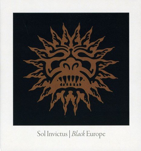 CD cover: black background with a golden, sun-like face design.
